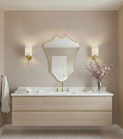 Crowned Curve brass mirror in elegant bathroom with wall sconces