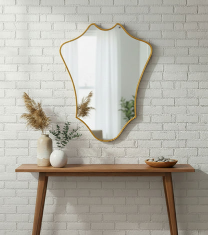 Crowned Curve brass mirror styled above a wooden console table