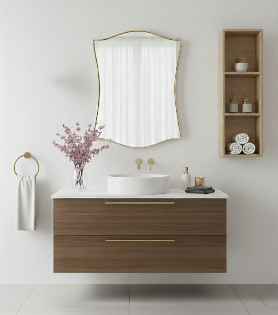 Graceful shield brass mirror styled above modern wooden bathroom vanity