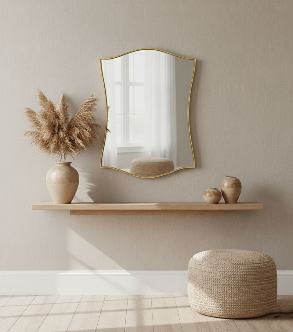 Handmade shield mirror with elegant curved edges in minimalist interior