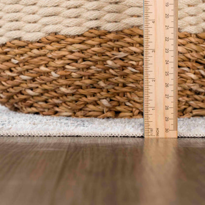 Woven basket with a ruler showing measurements on a wooden floor.