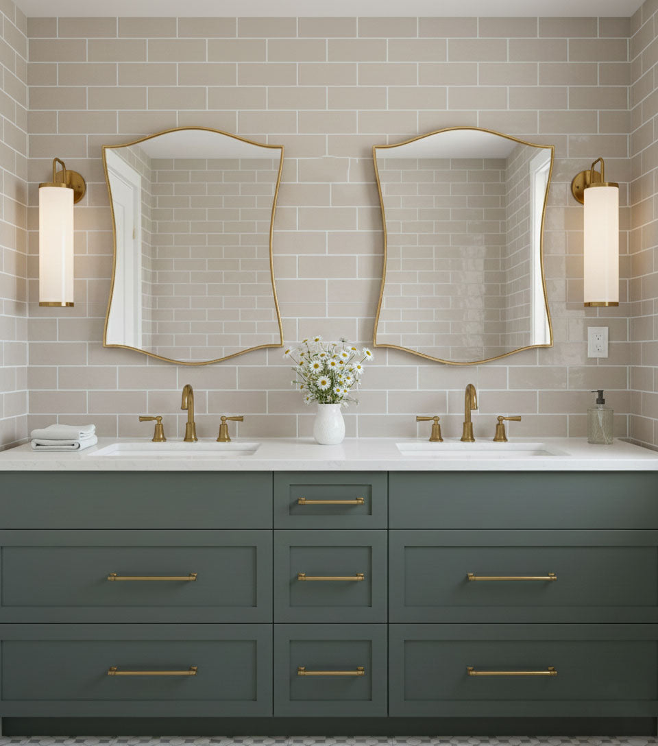 Pair of graceful shield mirrors over double bathroom vanity with brass fixtures