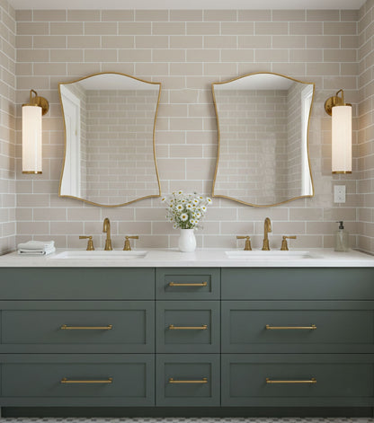 Pair of graceful shield mirrors over double bathroom vanity with brass fixtures