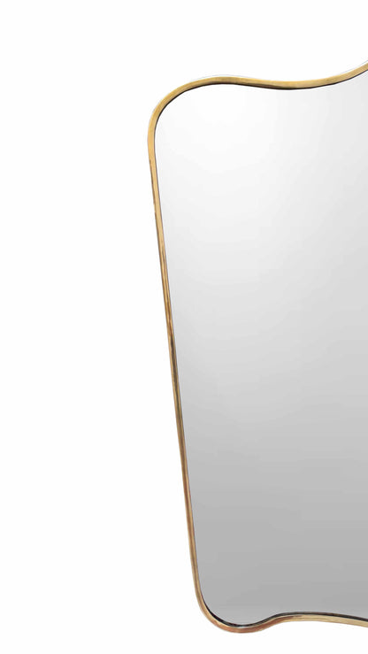 Curved brass mirror with an organic, irregular shape and a slim, unlacquered brass frame on a white background.