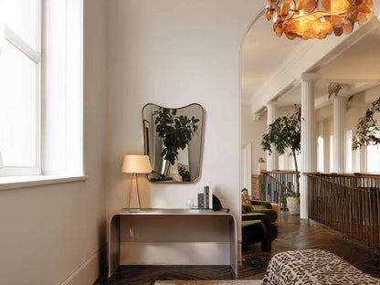 curved brass mirror in living room