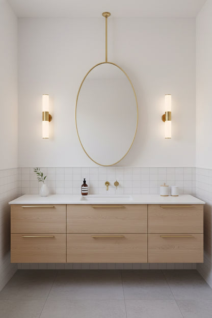 Ceiling-mounted oval mirror with brass rod in modern bathroom