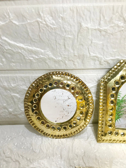 a couple of mirrors sitting on top of a wall