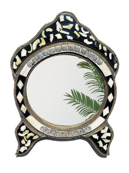 a mirror with a palm leaf on it