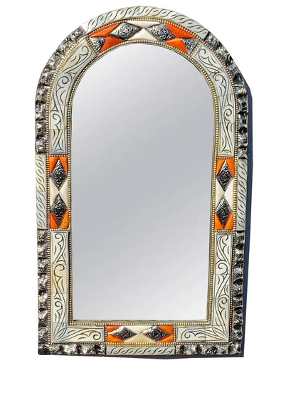 a decorative mirror with an orange and white border