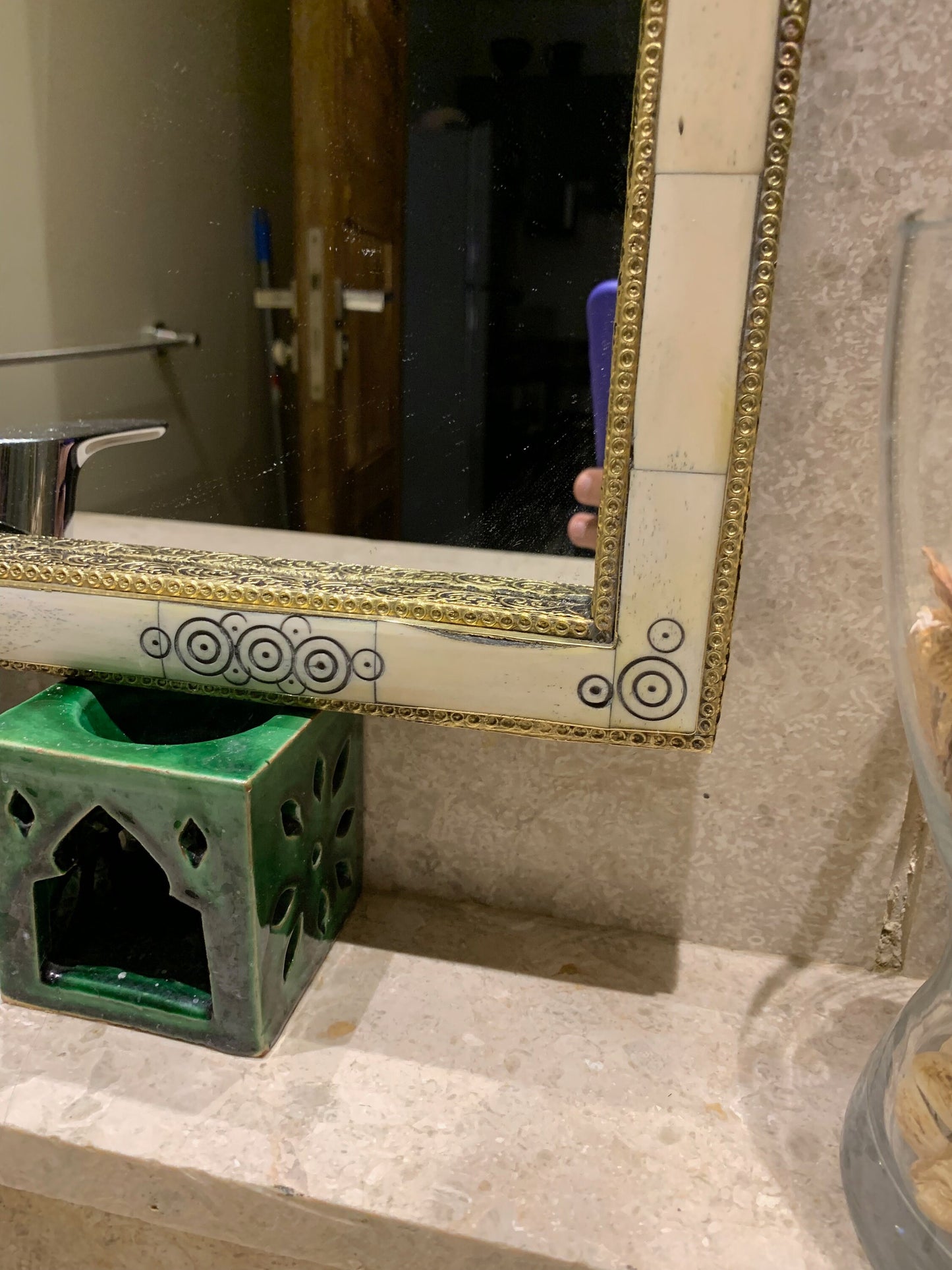 a bathroom sink with a mirror and soap dispenser