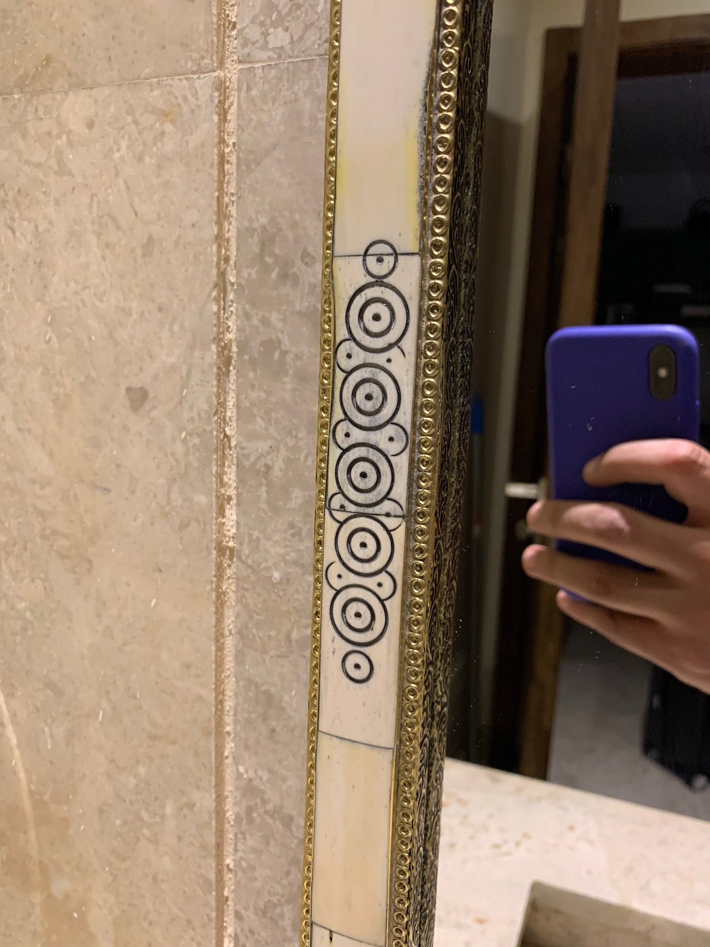 a person taking a picture of a bathroom mirror