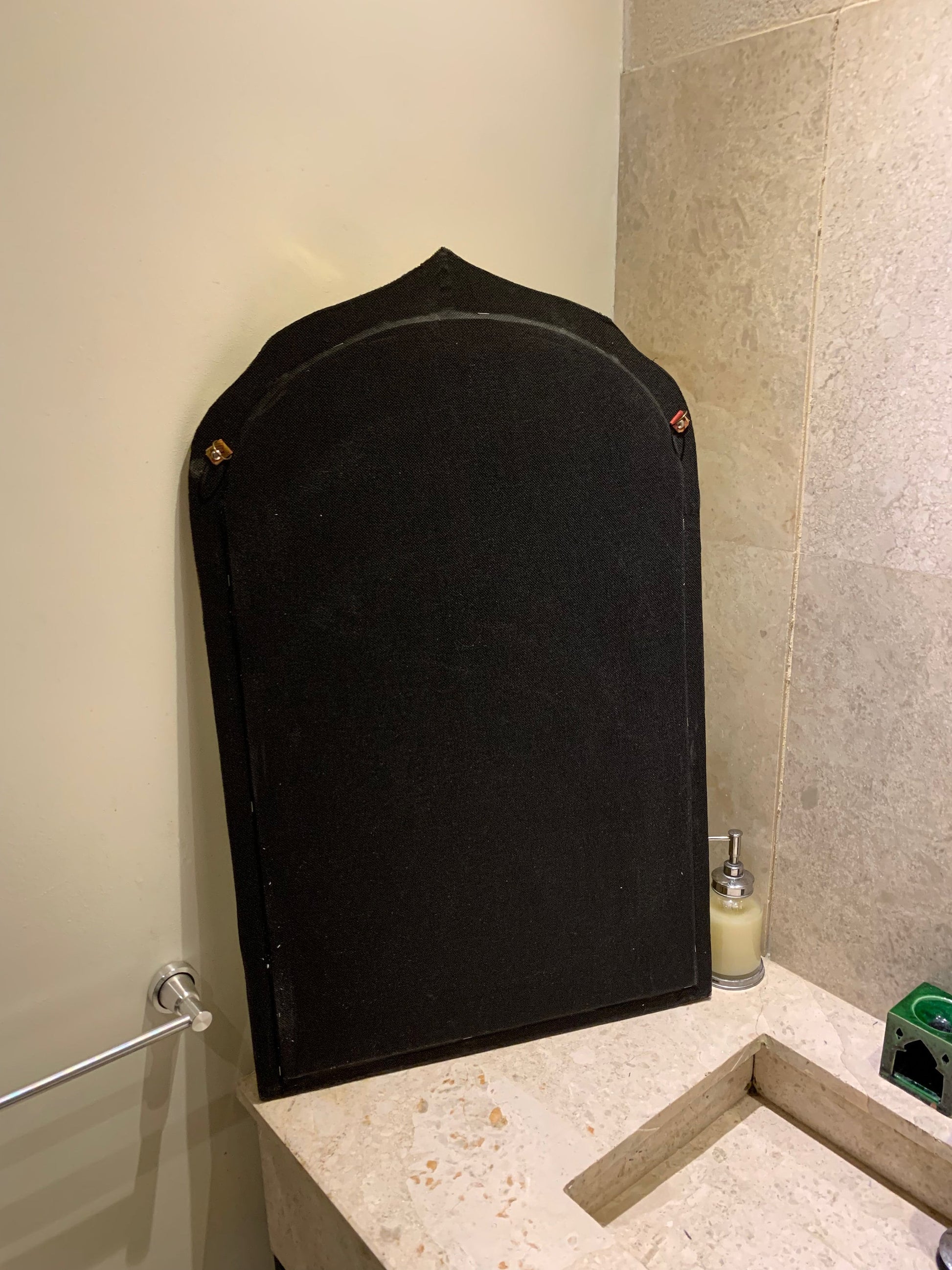 a bathroom with a large black object on the counter