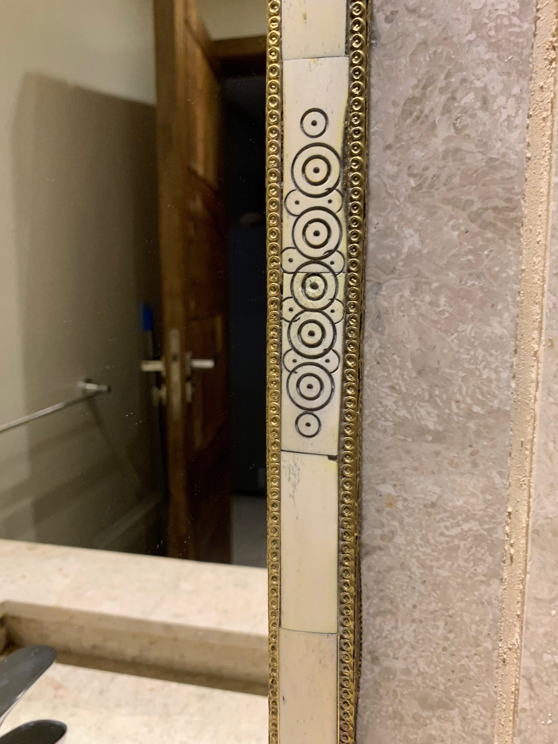 a mirror that is on the wall in a bathroom