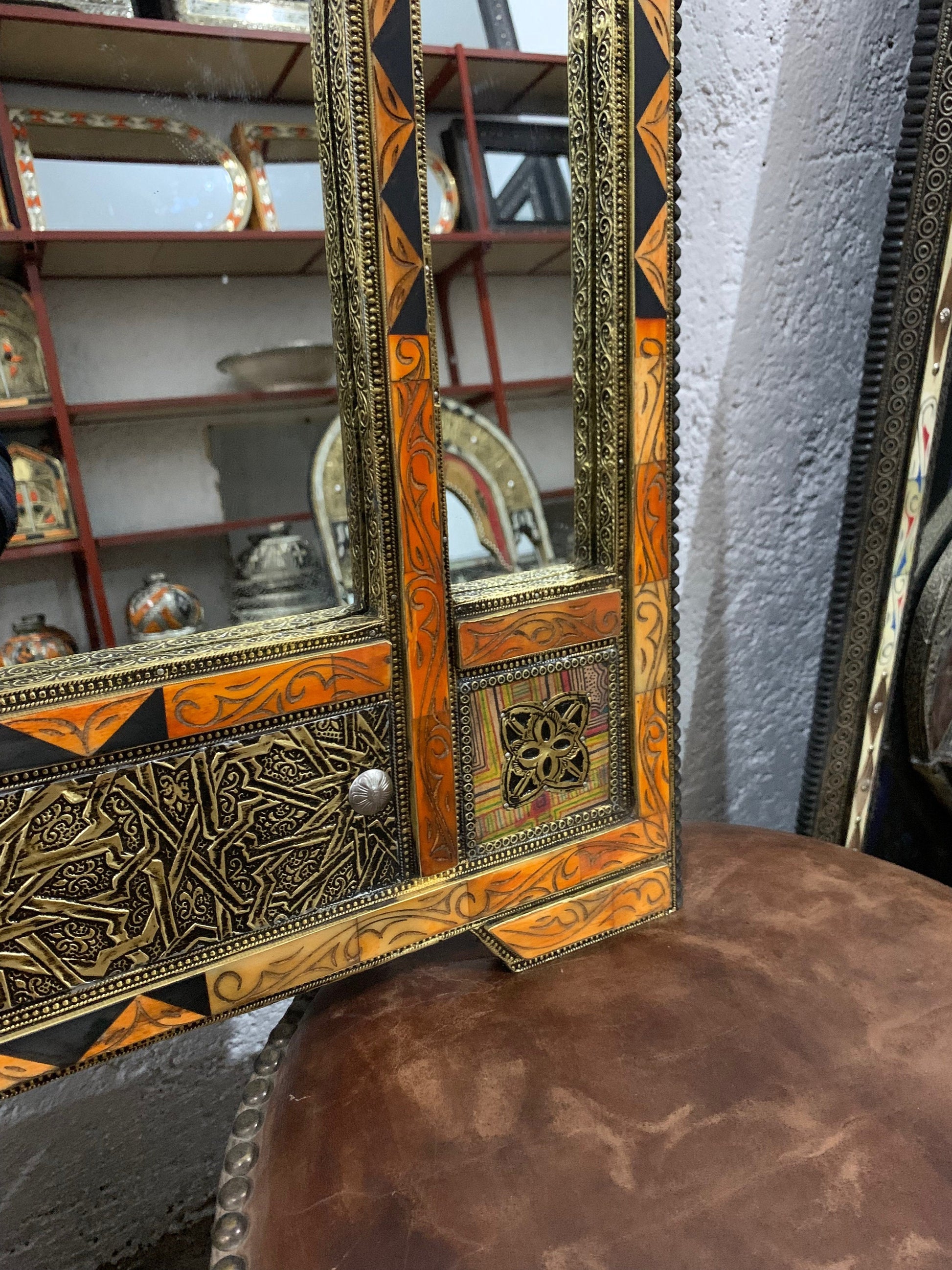 a mirror sitting on top of a wooden table