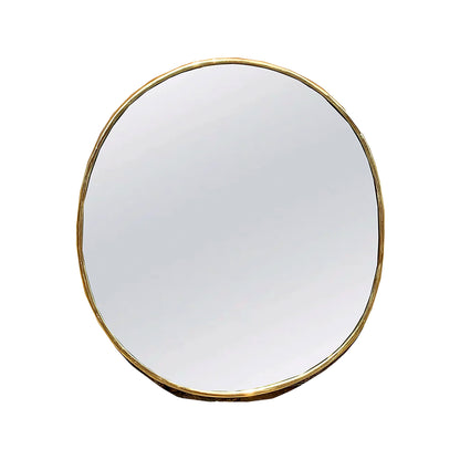 a round mirror with a gold rim on a white background