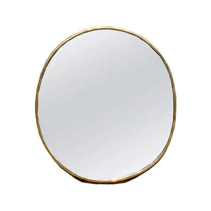 a round mirror with a gold rim on a white background