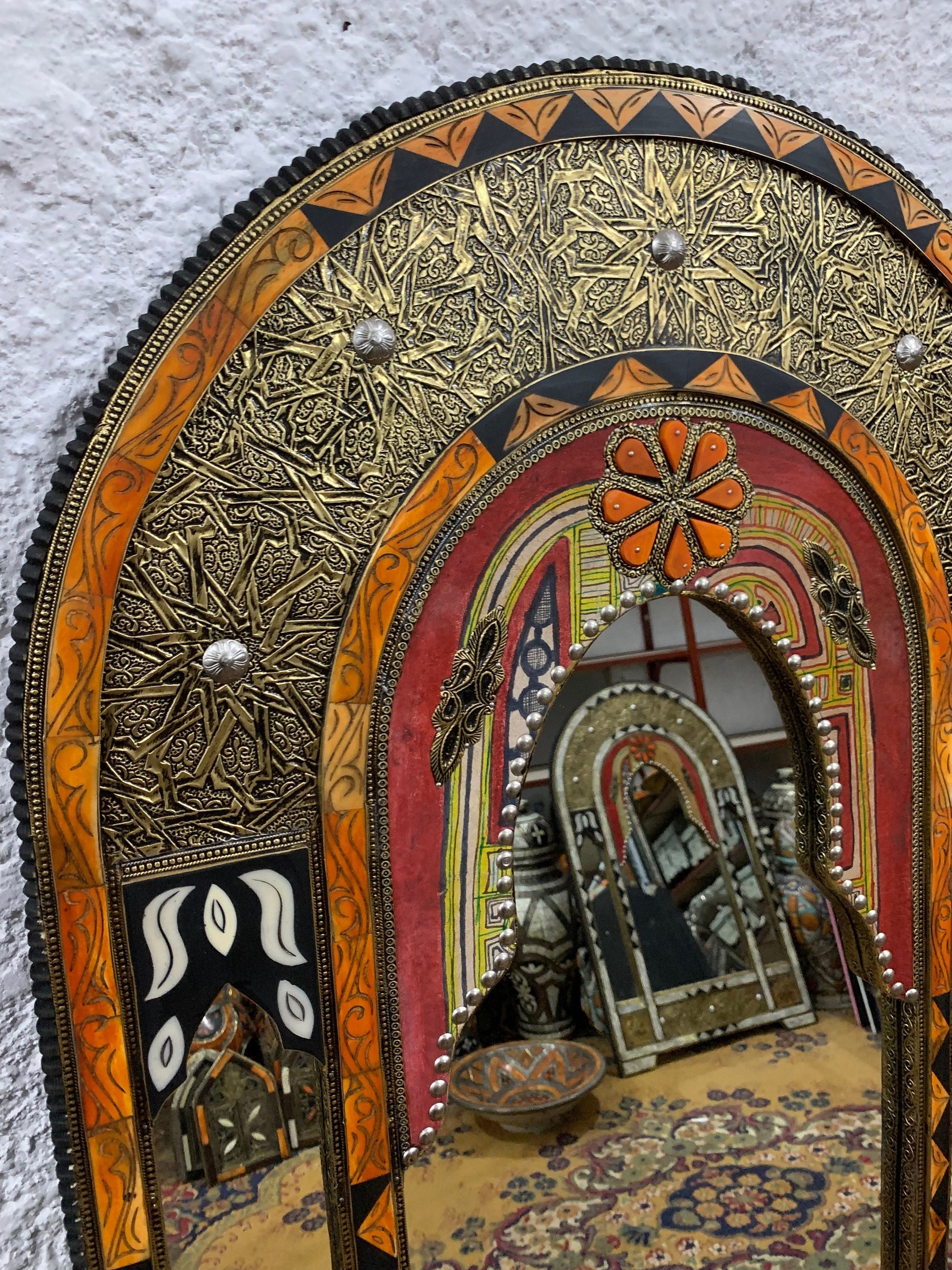 a mirror that is on the side of a wall