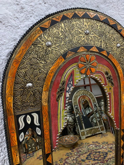 a mirror that is on the side of a wall