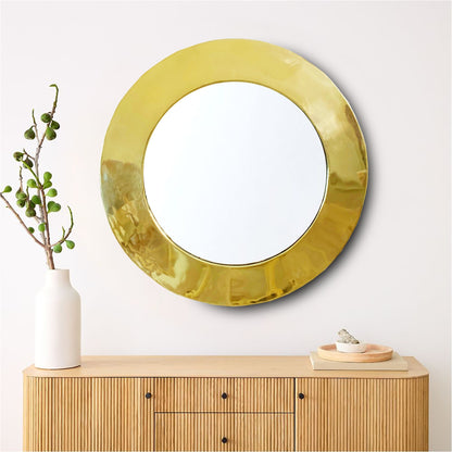 a round mirror sitting on top of a wooden dresser