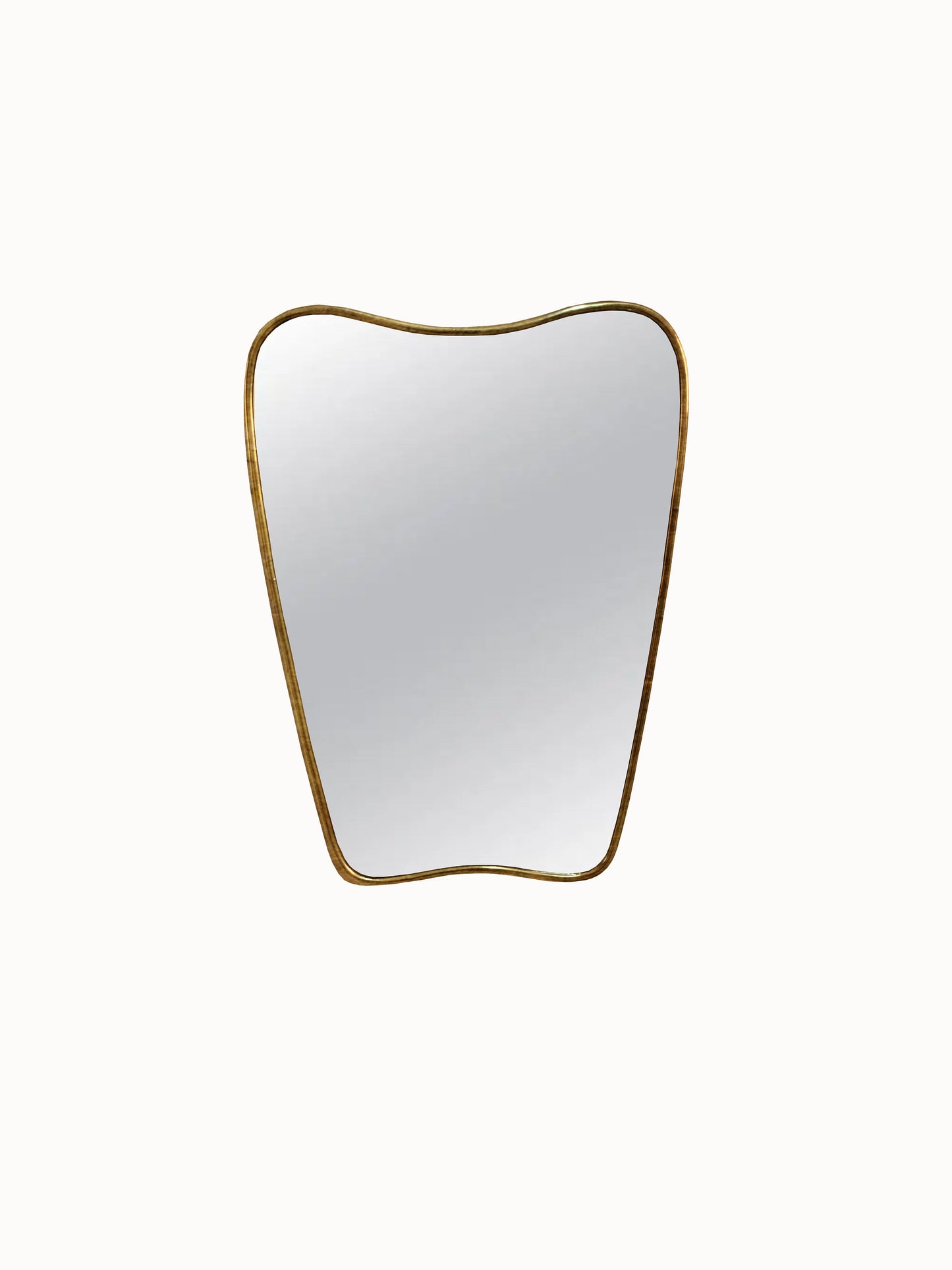 a white and gold apple shaped mirror on a white wall
