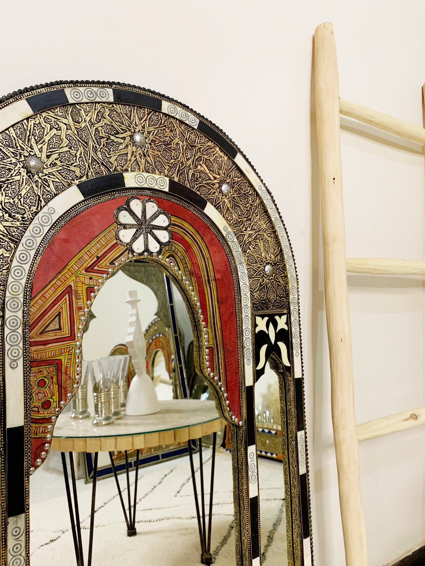 a table with a mirror on top of it next to a ladder