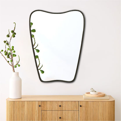 a mirror sitting on top of a wooden dresser