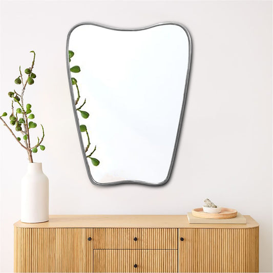 a mirror sitting on top of a wooden dresser