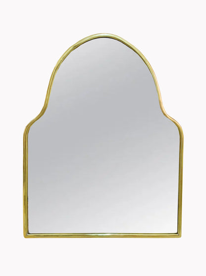 a gold framed mirror on a white wall