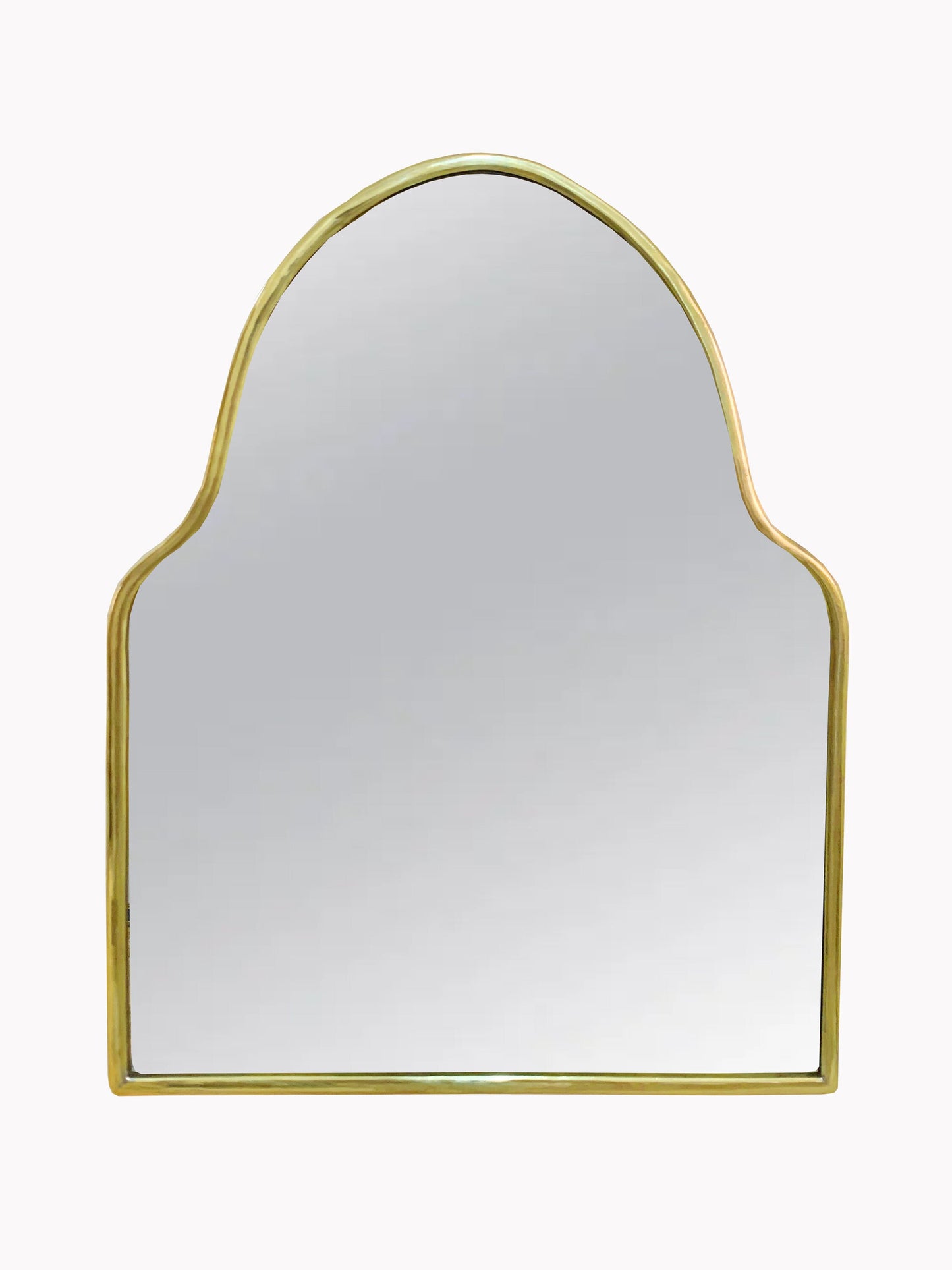 a gold framed mirror on a white wall