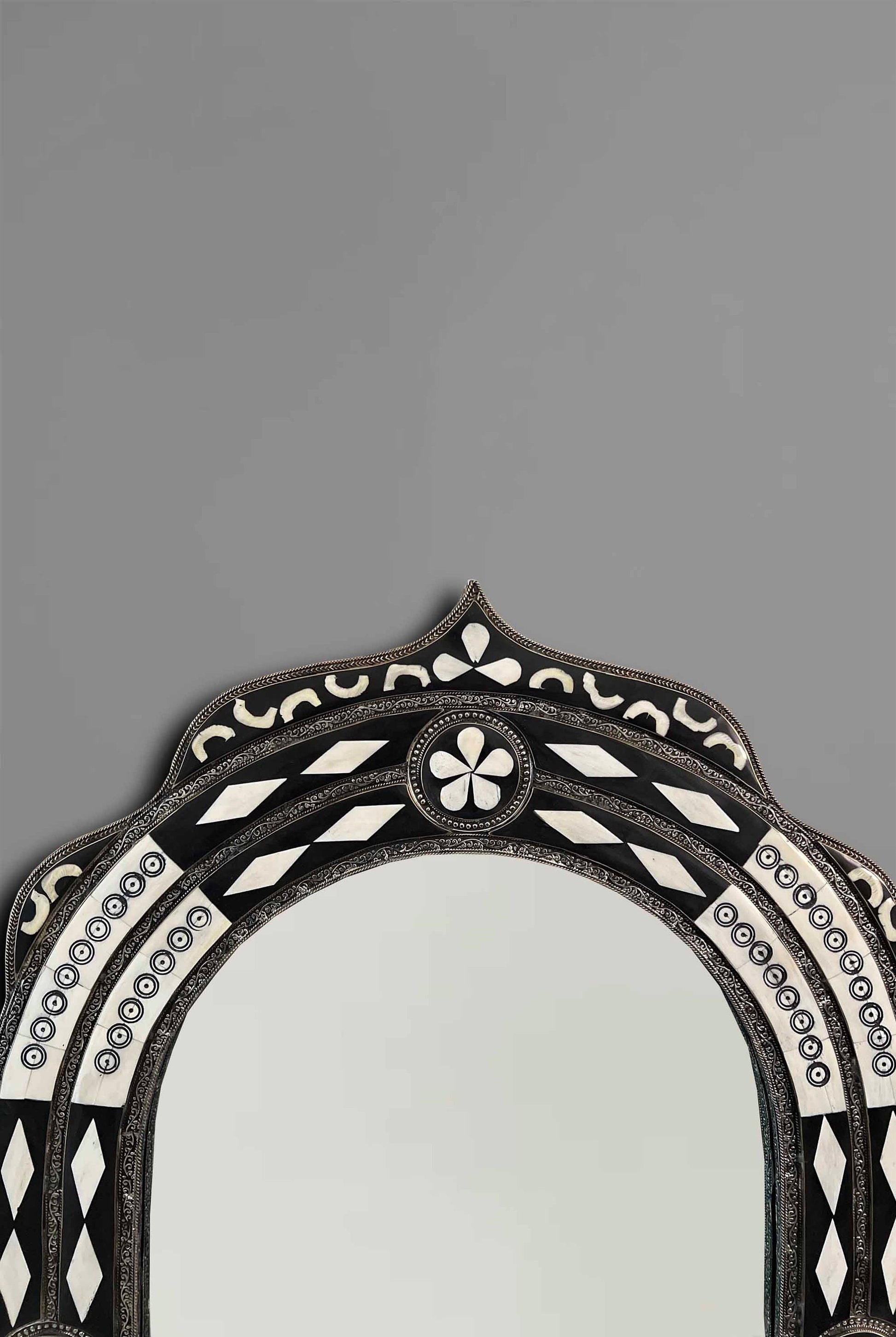 a mirror with a black and white design on it