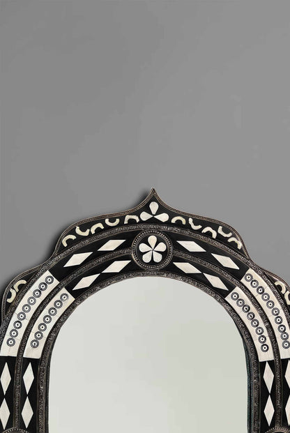 a mirror with a black and white design on it