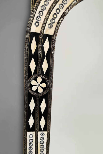 a mirror with a design on the side of it