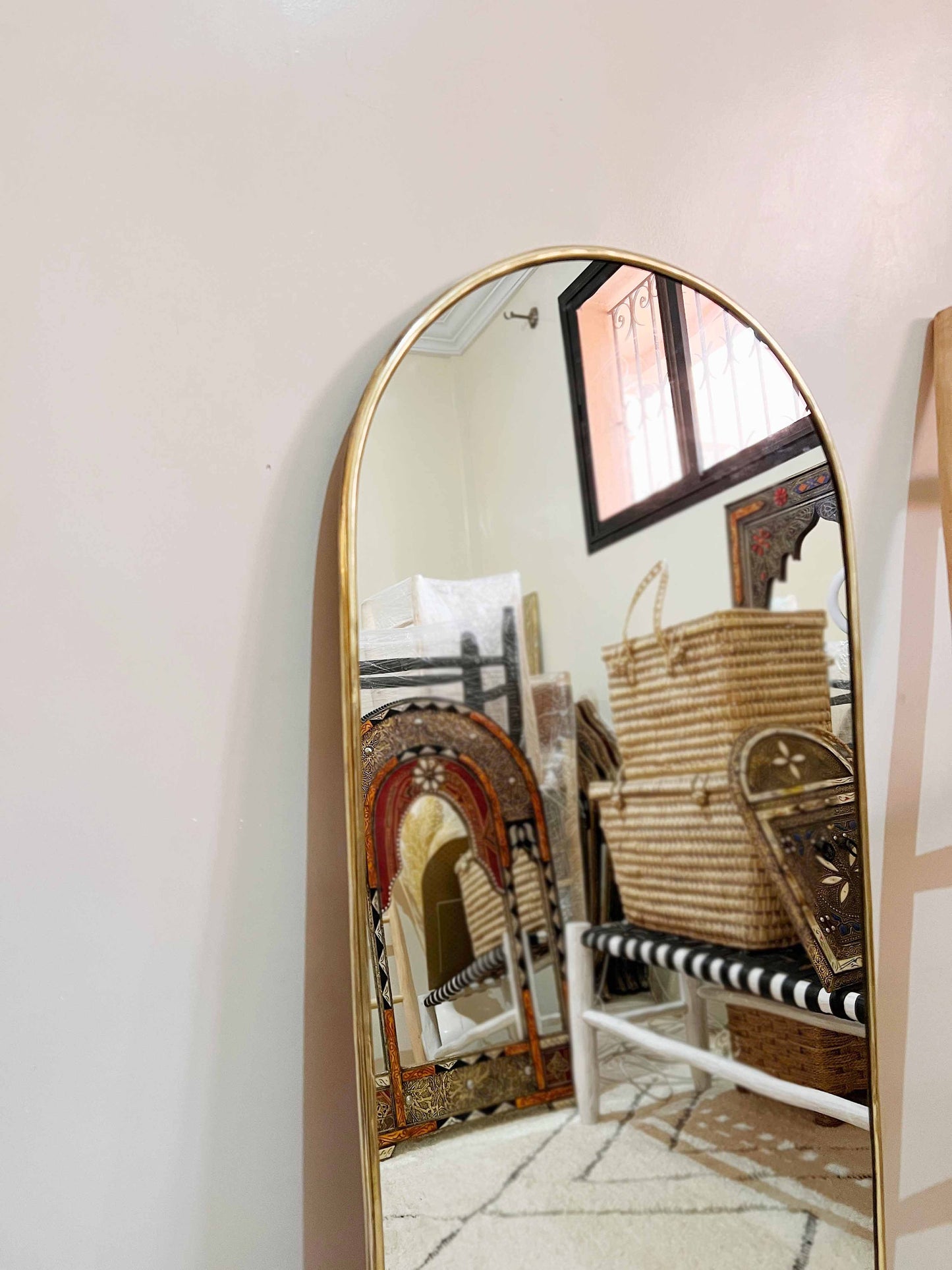 a large mirror sitting on top of a white floor