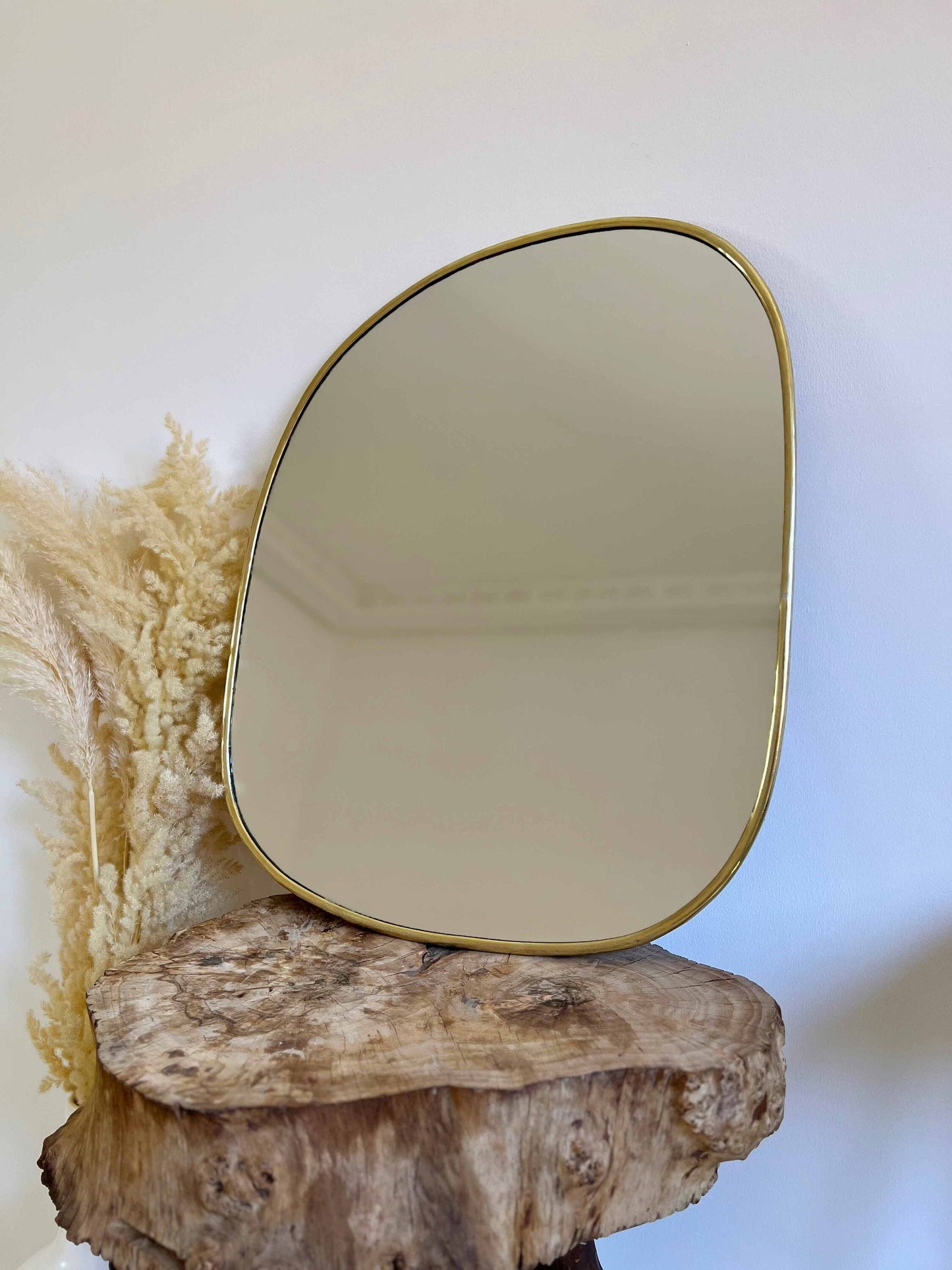 a mirror sitting on top of a piece of wood