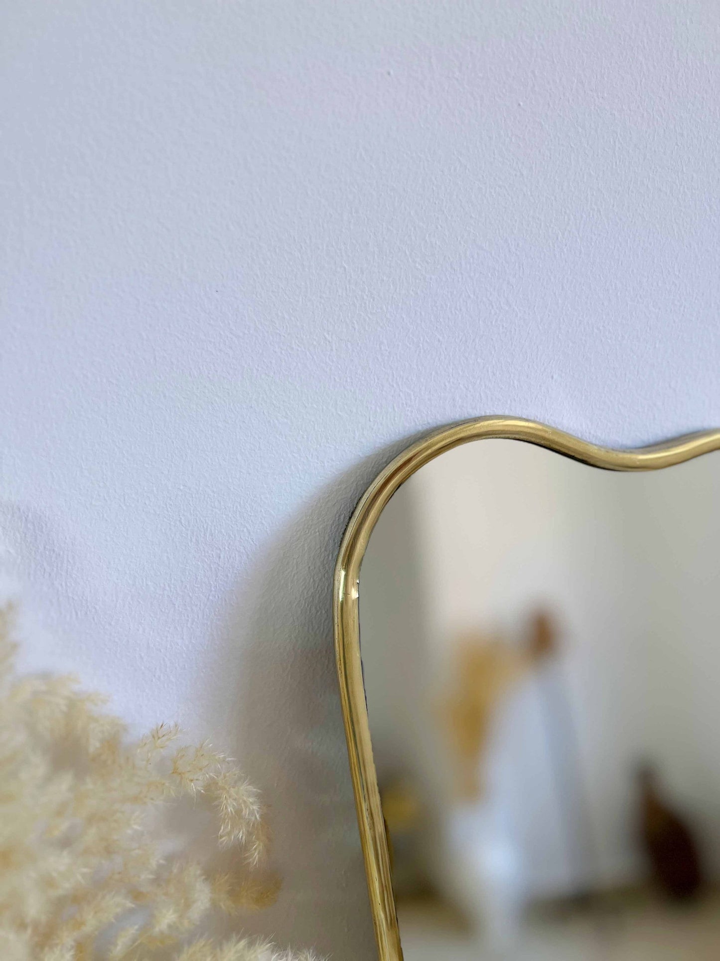 a heart shaped mirror sitting on top of a table