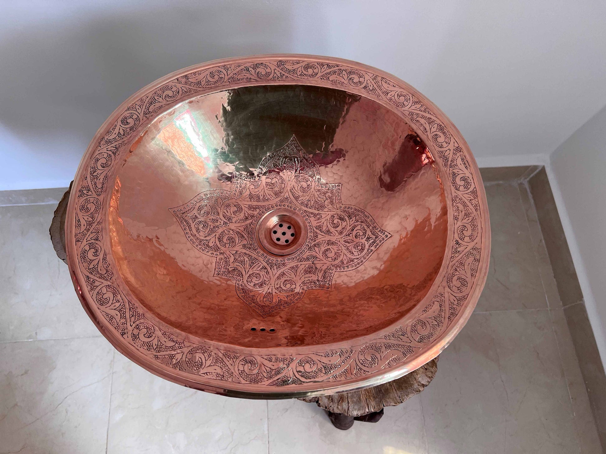 a large copper sink in a bathroom