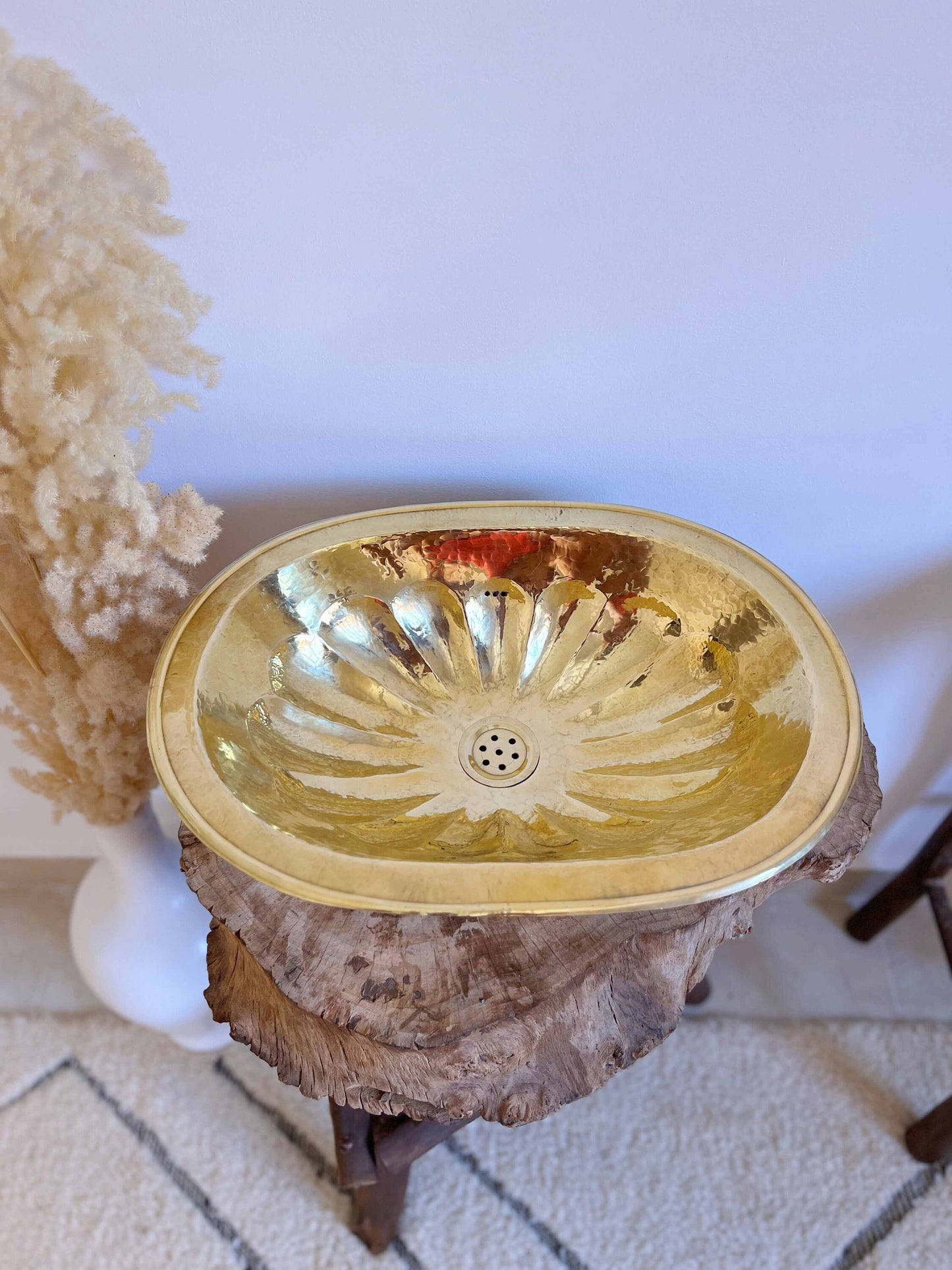 a gold bowl sitting on top of a tree stump