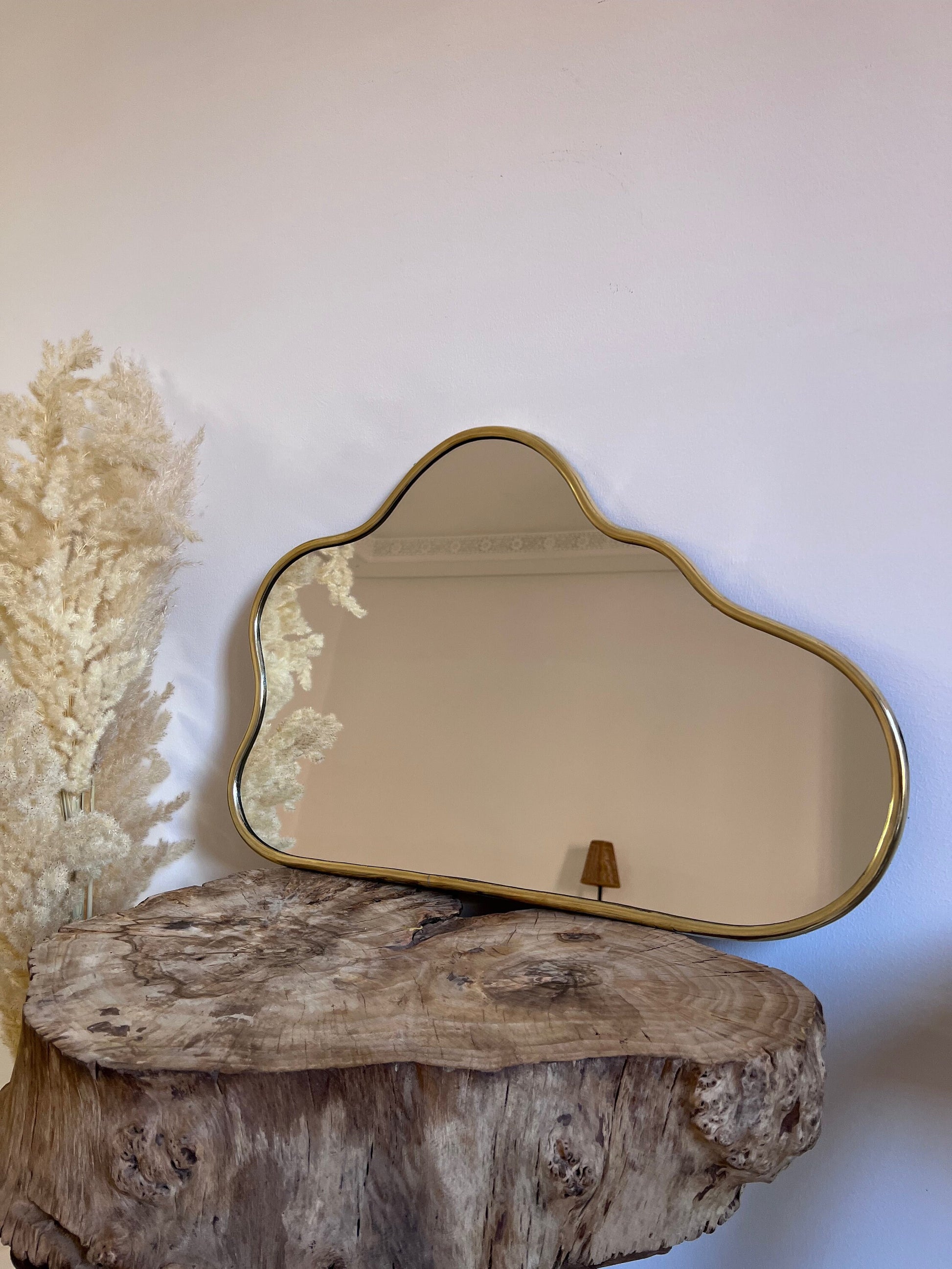 a mirror sitting on top of a wooden table