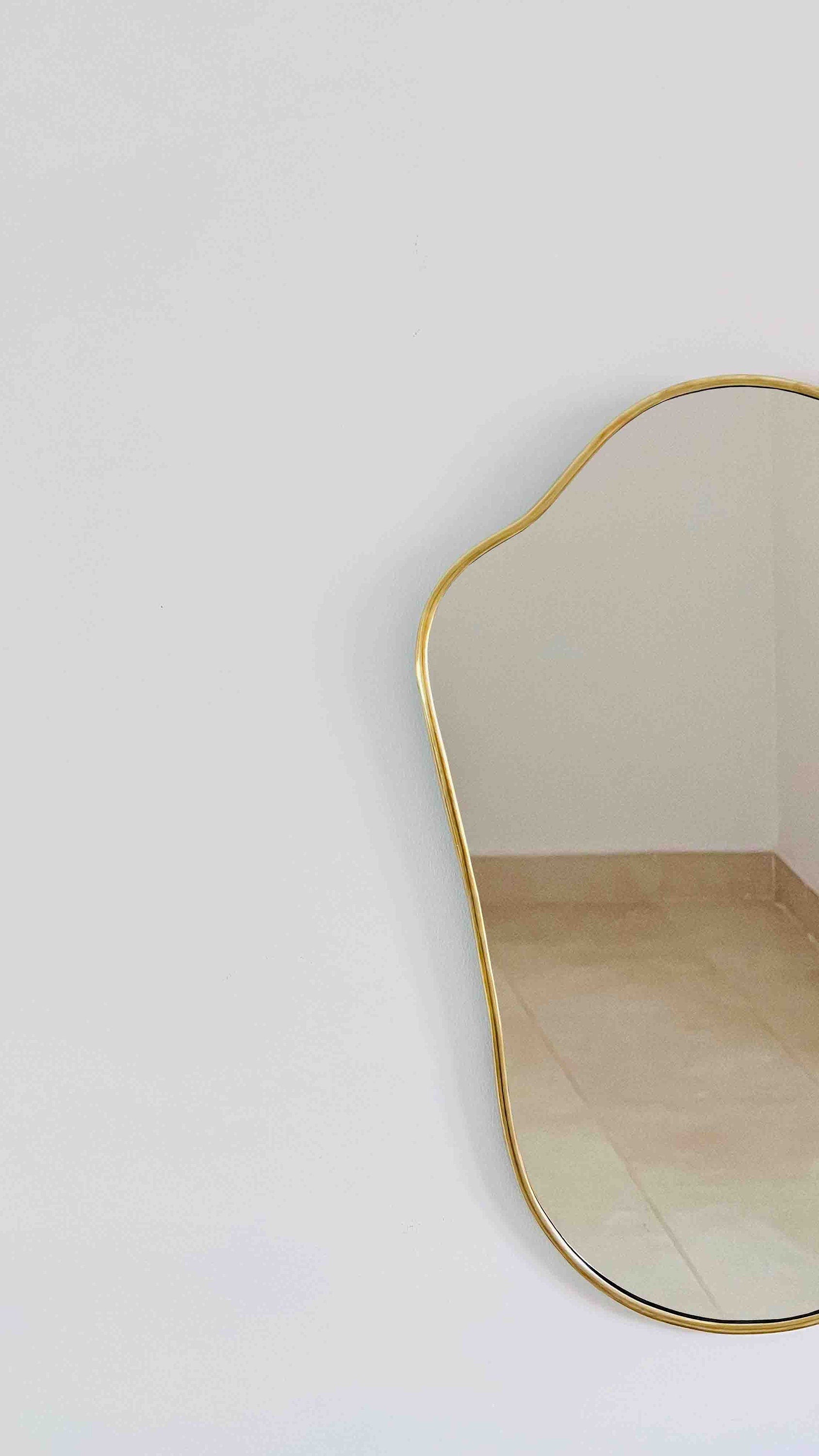 a mirror that is on the wall in a room