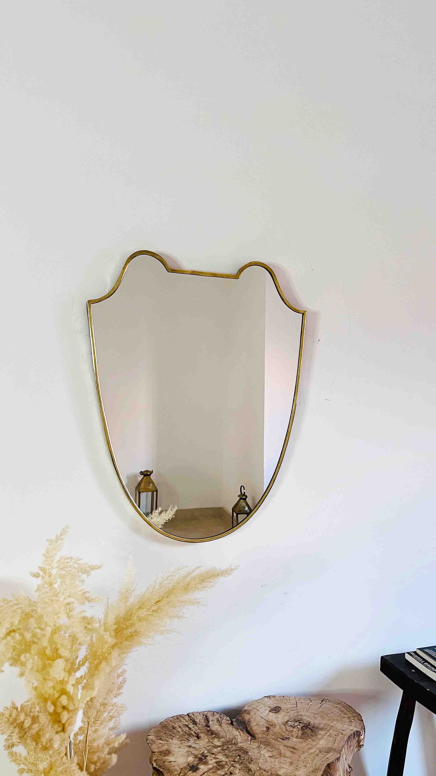a mirror hanging on a wall above a table